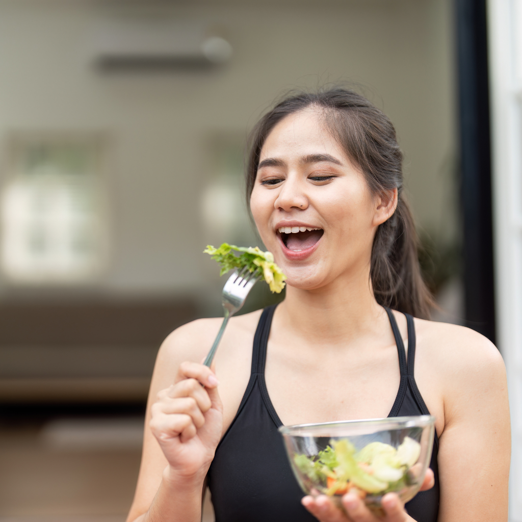 Photo of a woman eating a salad