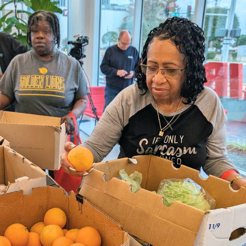 Market participant picking out an orange